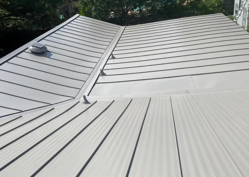 Solar attic fan installed on a metal roof for Roof Ventilation in Olathe